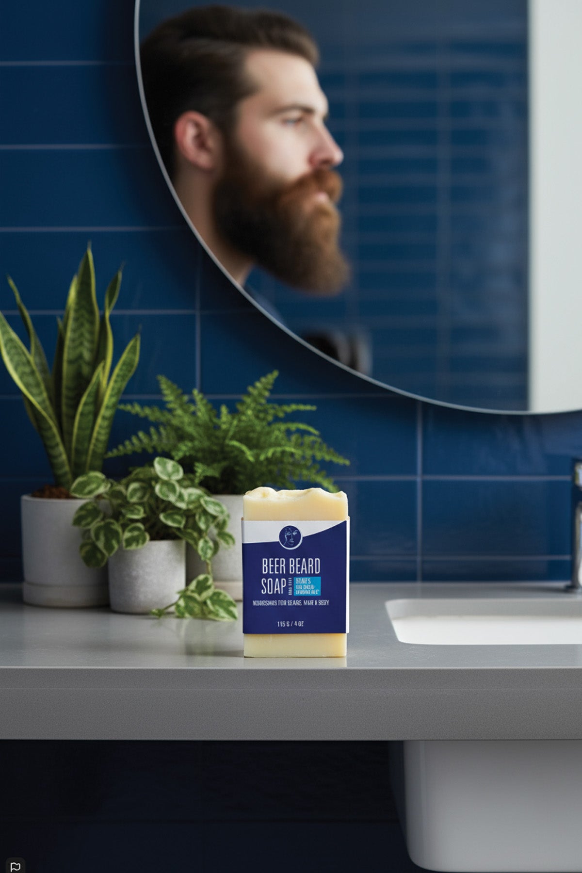 Bar of soap with packaging labeled 'Beer Beard Soap' on a bathroom counter, reflected in a mirror.