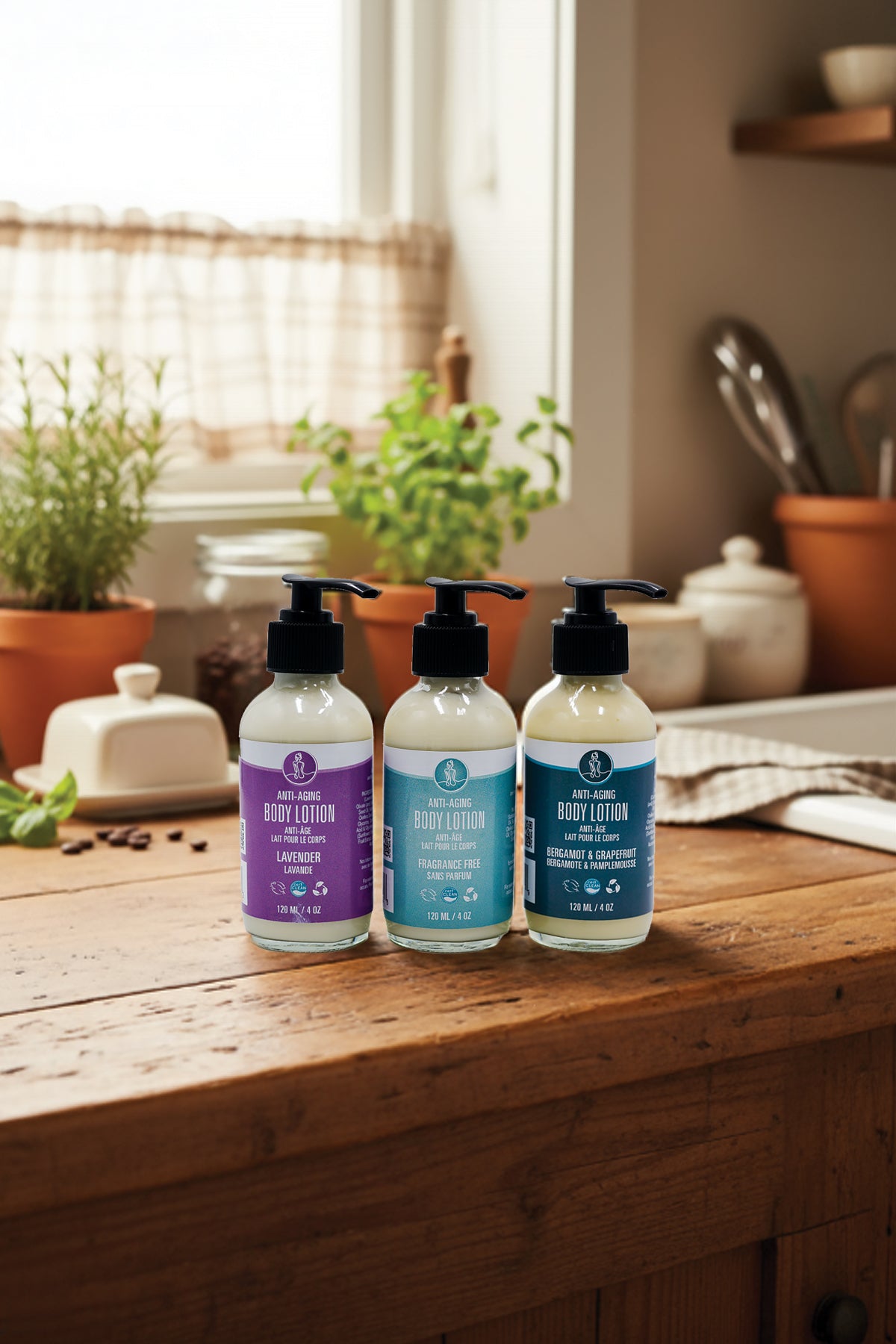 Three bottles of body lotion on a wooden surface with a kitchen background