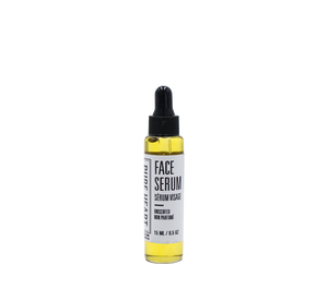 Face serum bottle with dropper on a white background