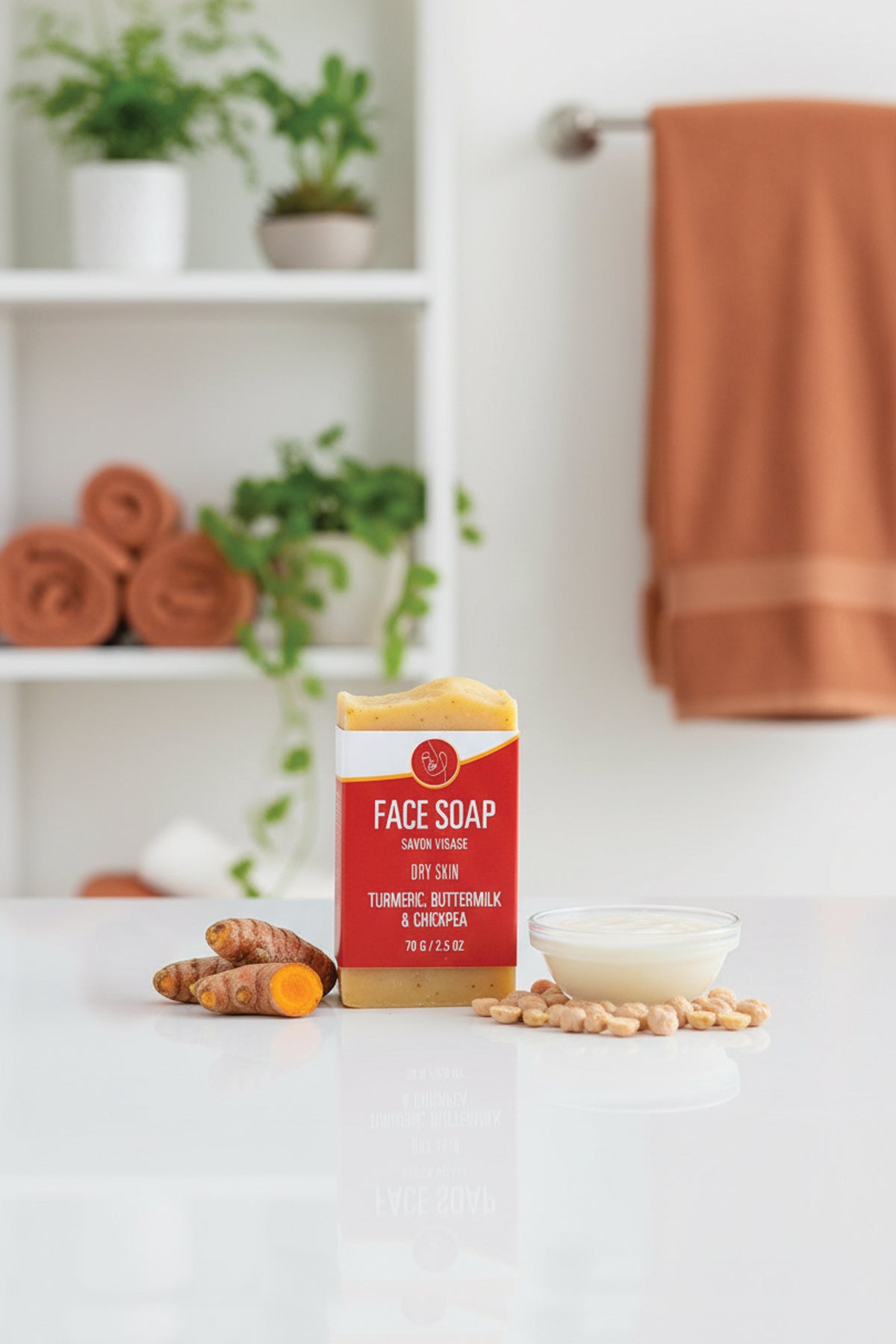 Face soap bar with turmeric and chamomile on a white surface with a blurred background