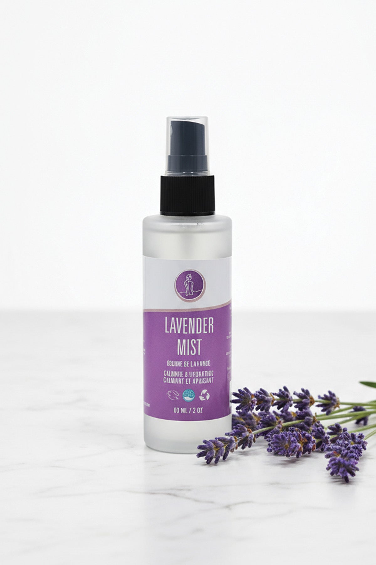 Lavender mist spray bottle with lavender flowers on a white background