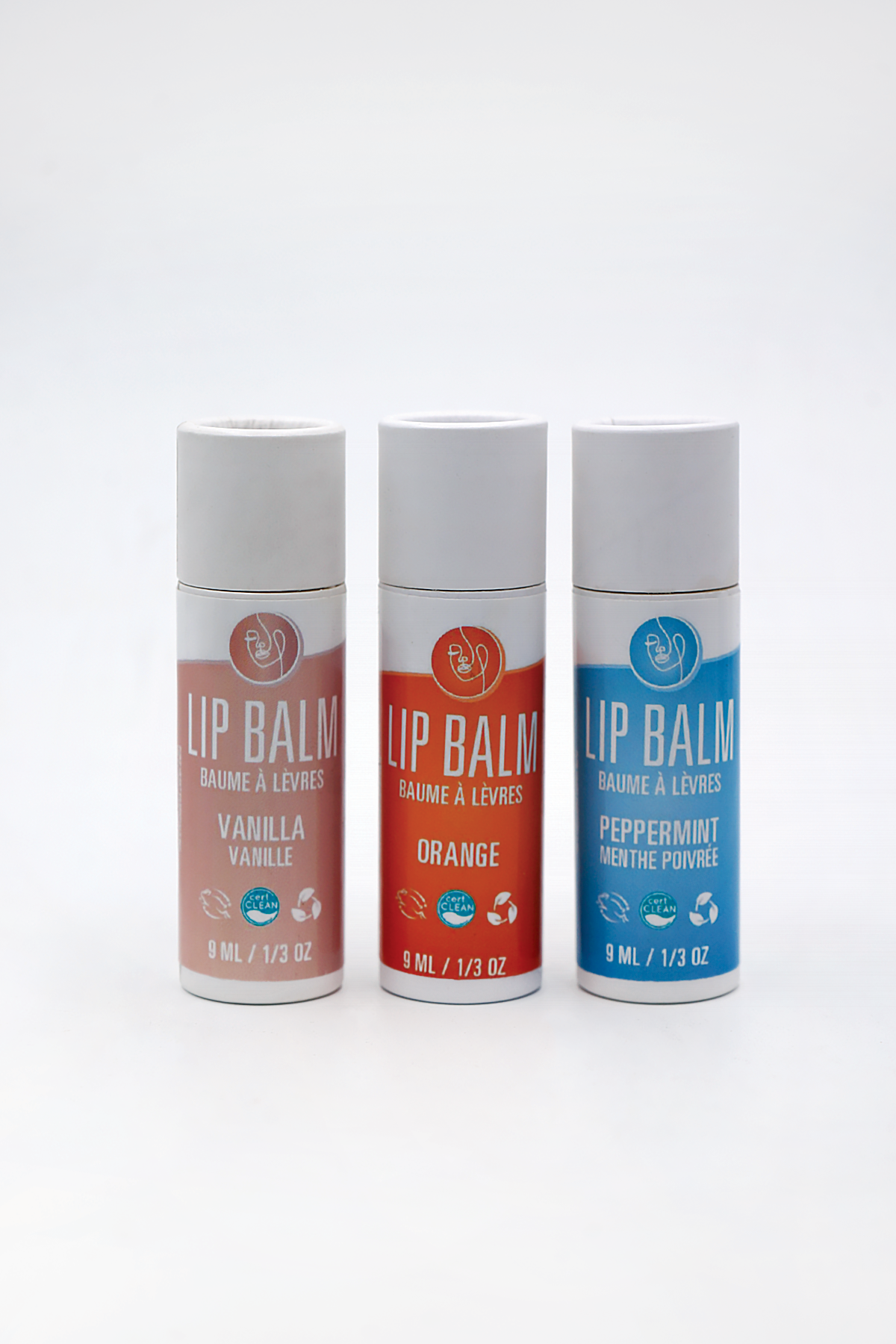 Three lip balm containers with different flavors on a white background