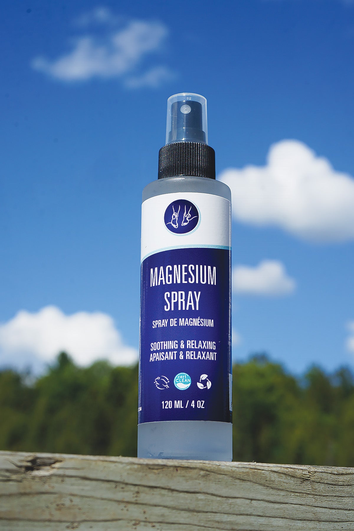 Bottle of magnesium spray with a blue label against a natural background