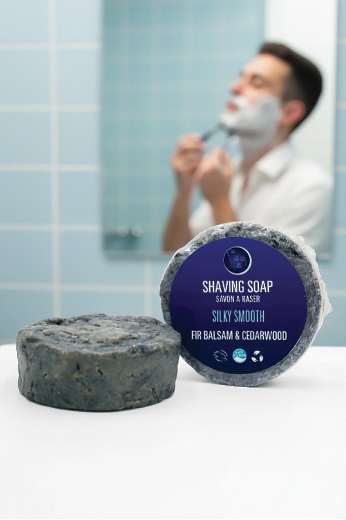 Shaving soap bar with packaging labeled 'Silky Smooth' in a bathroom setting.