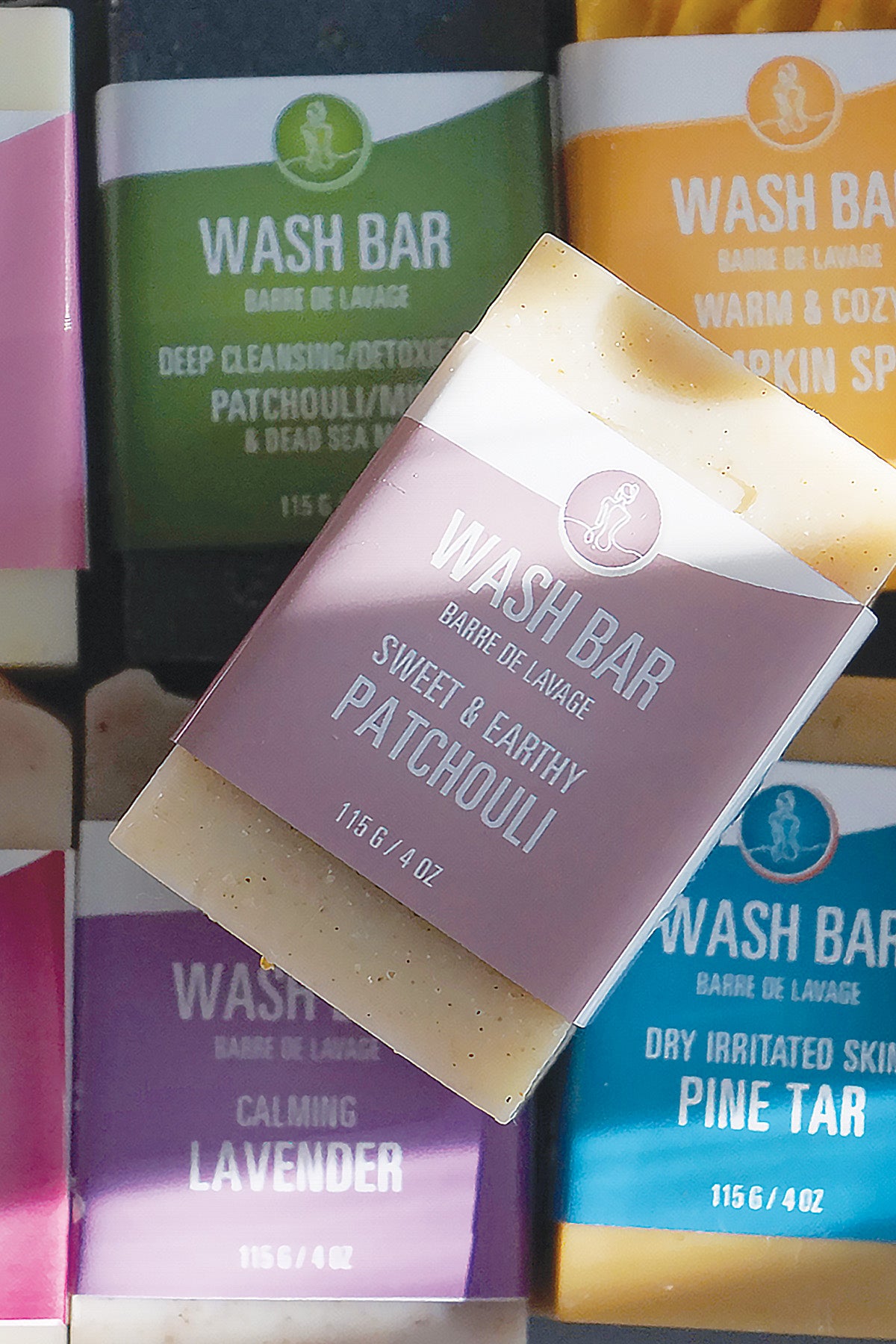 Bar of soap with packaging labeled 'Sweet & Earthy Patchouli' among other soap bars.