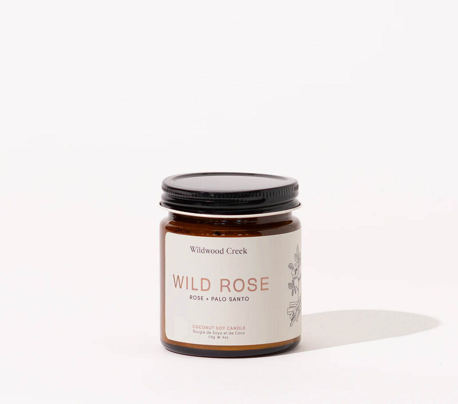 Candle jar labeled 'Wild Rose' by Wildwood Creek on a white background